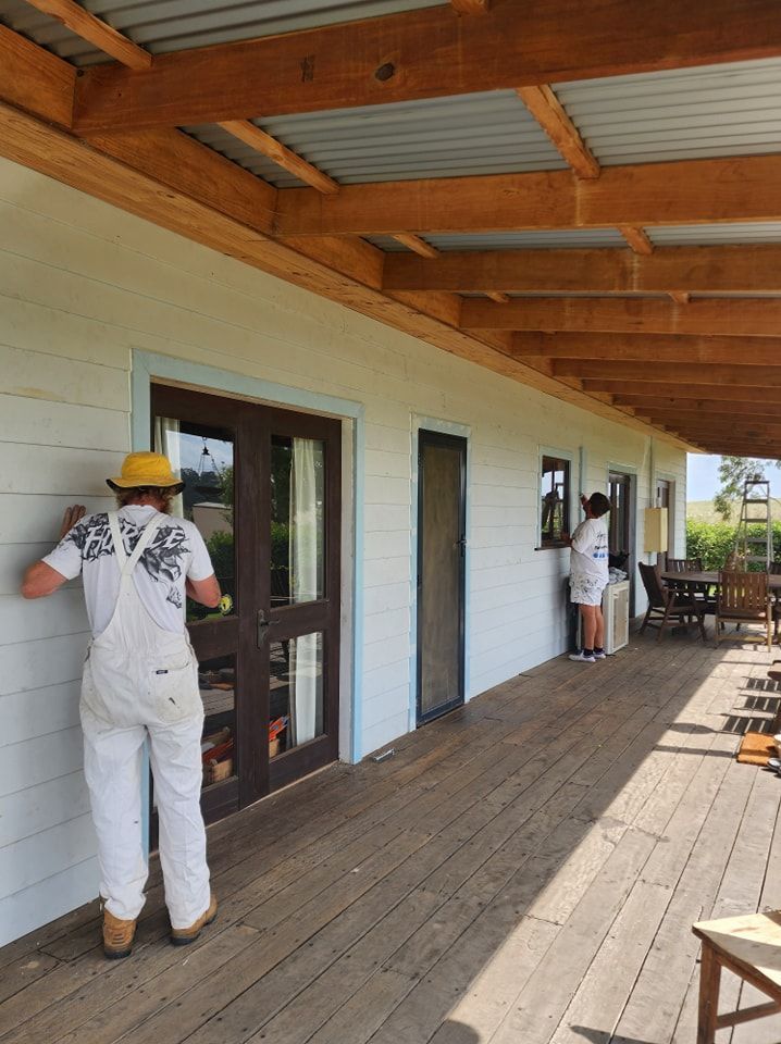 Workers Painting a White Porch with Wooden Beams and Doors — Matty Stewart Painting & Decorating in Bathurst, NSW