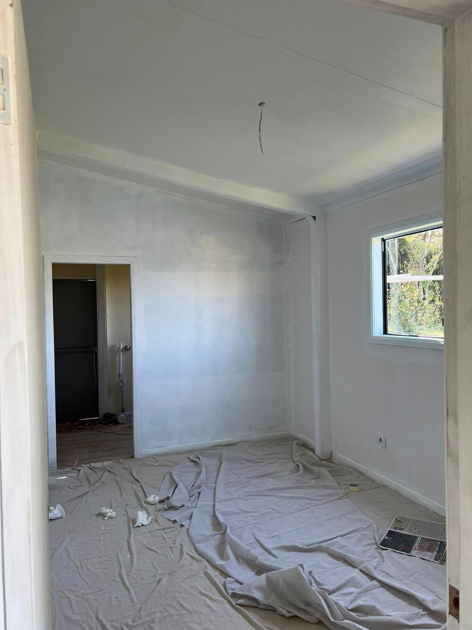 A White Room Under Renovation with Plastic Covered Floor — Matty Stewart Painting & Decorating in Mudgee, NSW