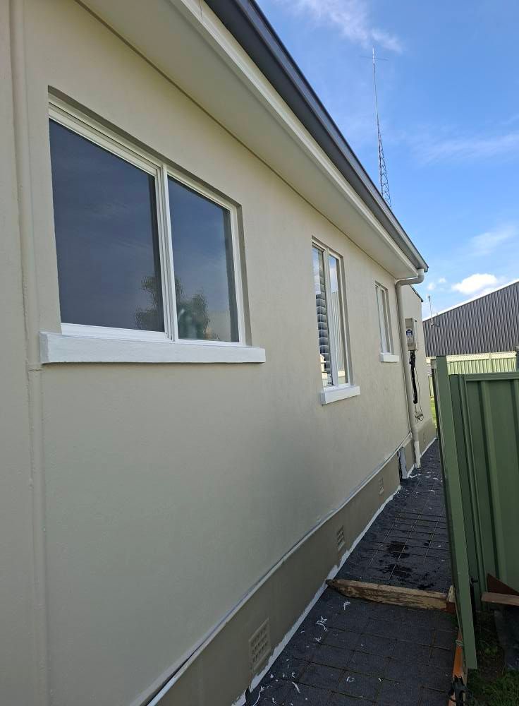 Side View of A Beige House with Windows and A Narrow Paved Walkway — Matty Stewart Painting & Decorating in Mudgee, NSW