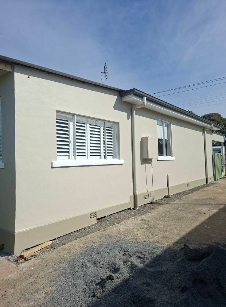 Single Story House Exterior with White Shutters and Gravel Driveway — Matty Stewart Painting & Decorating in Orange, NSW