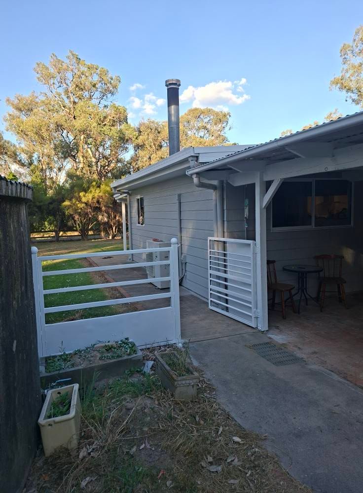Backyard Patio Beside Gray House — Matty Stewart Painting & Decorating in Bathurst, NSW