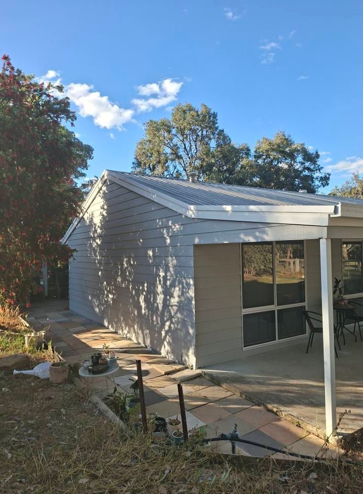 Backyard Patio Beside a Light Gray House with A White Roof — Matty Stewart Painting & Decorating in Dubbo, NSW