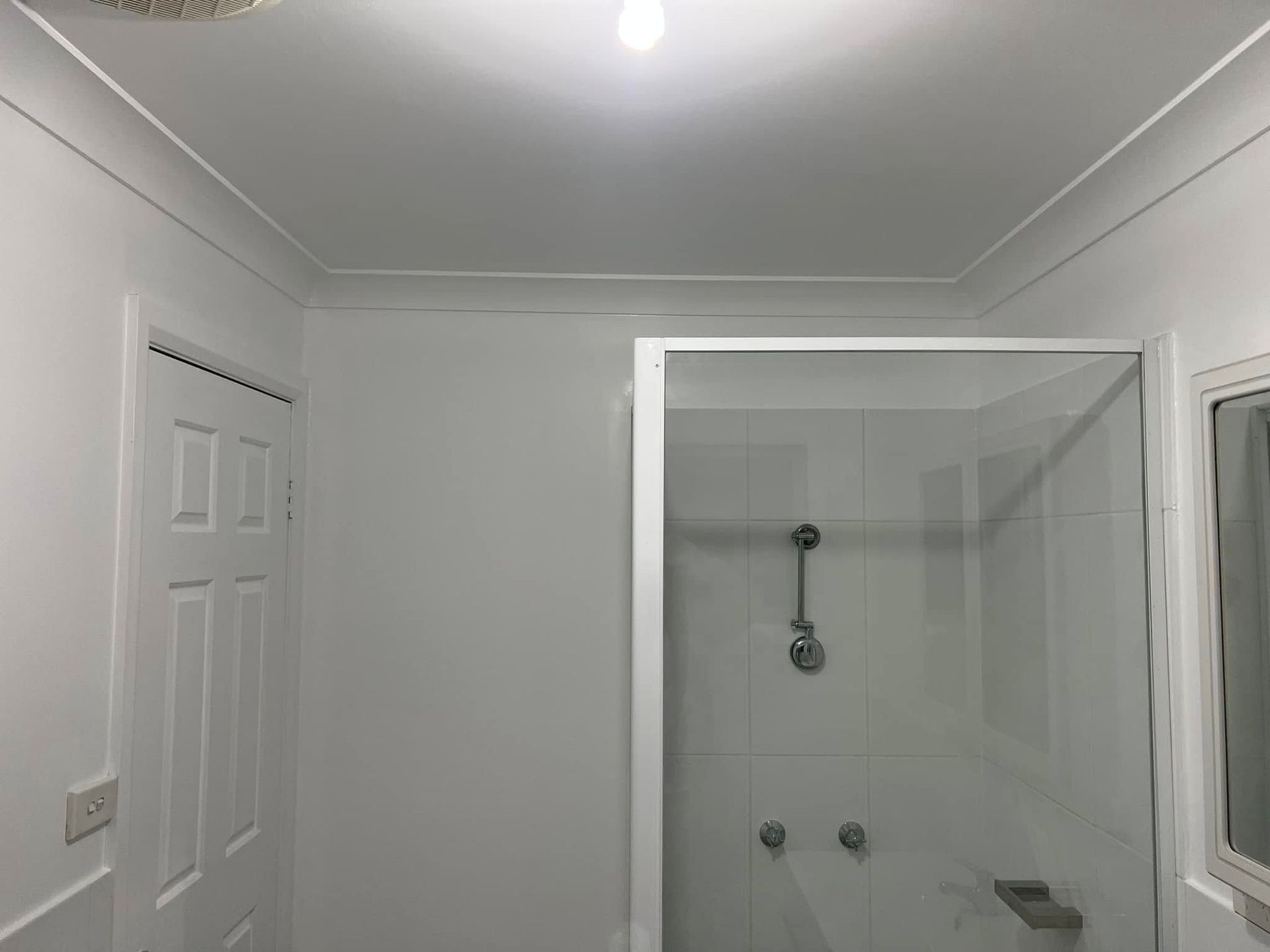 White Bathroom with A Shower Stall Viewed from The Entryway — Matty Stewart Painting & Decorating in Mudgee, NSW