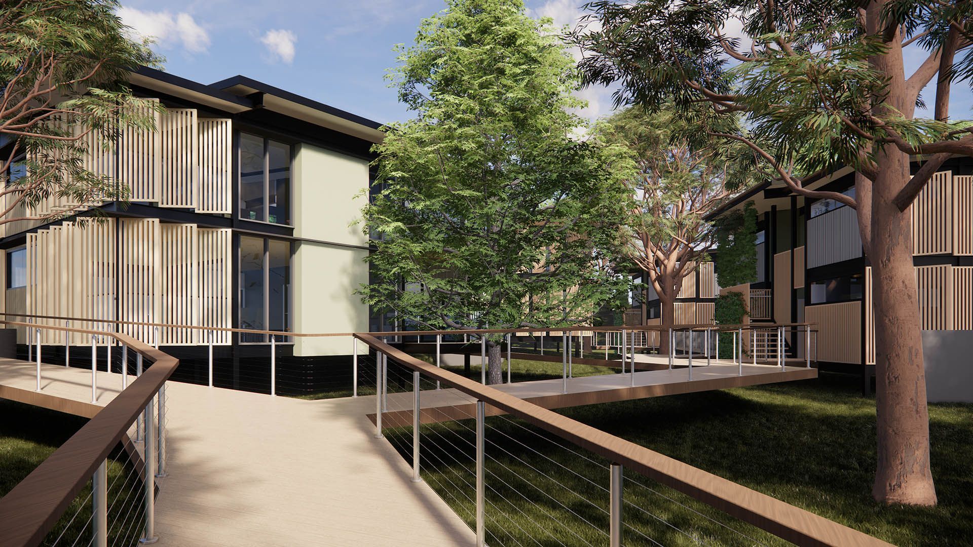 Modern apartment buildings with a tree-lined walkway and handrails in a sunny courtyard