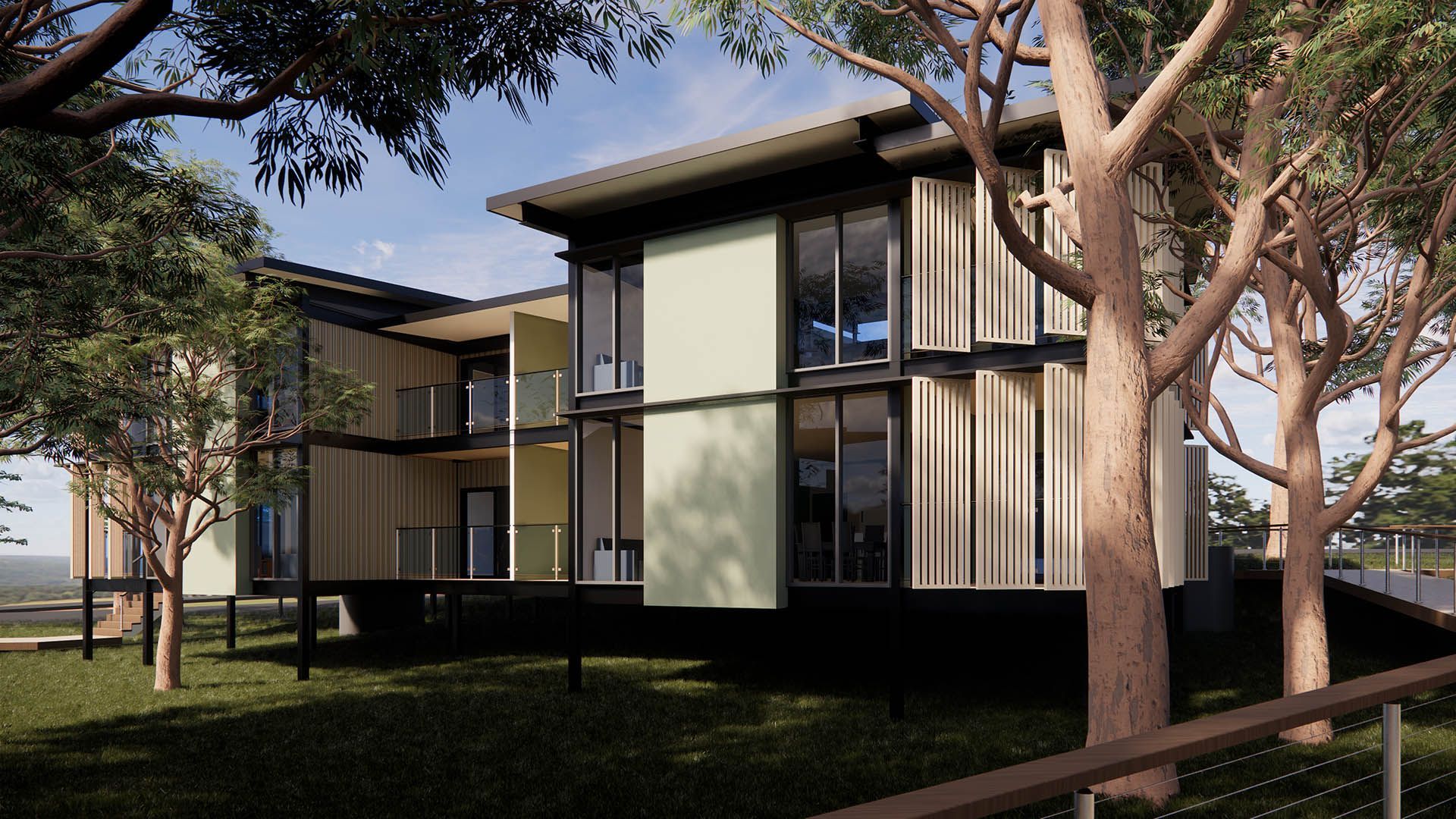 Modern apartment buildings with large windows among trees and grass in a sunny courtyard