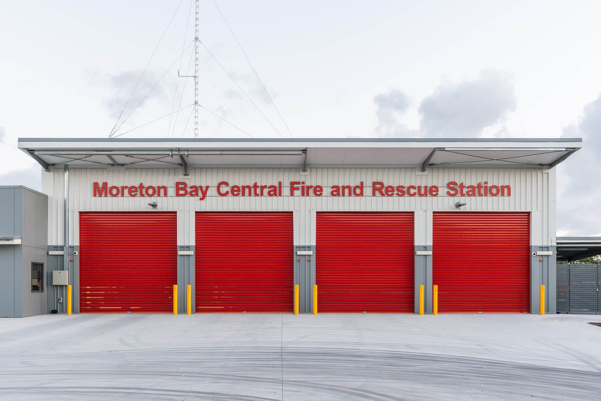 Moreton Bay Central Fire and Rescue Station with red garage doors and a white facade