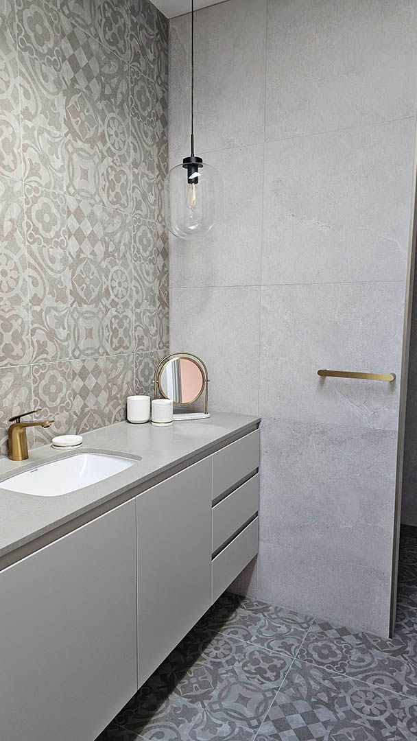 Modern bathroom vanity with sink, gray cabinets, patterned wallpaper, and a glass pendant light.