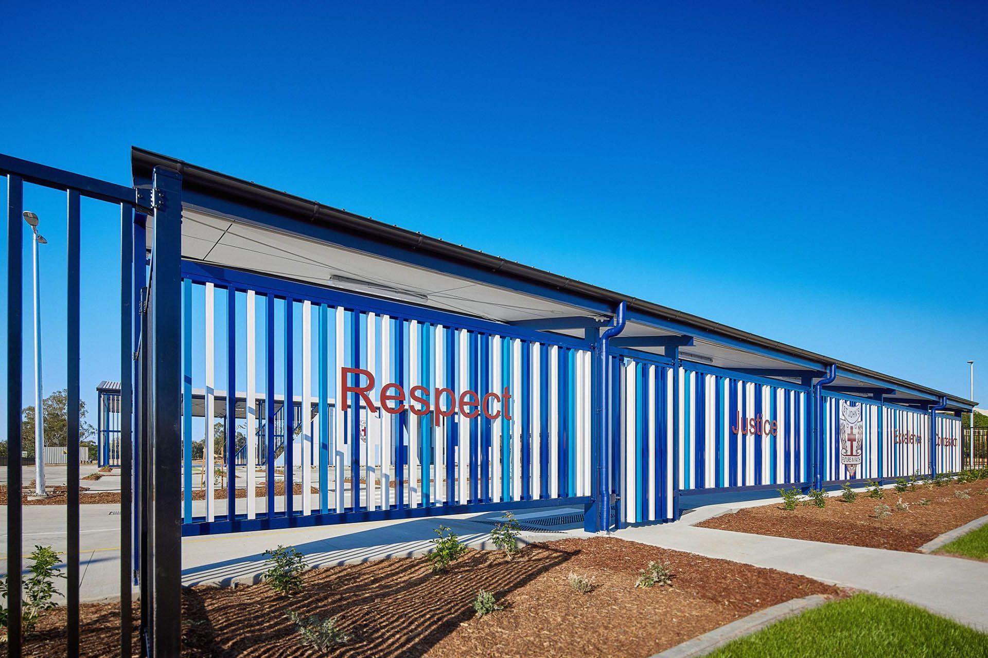 Blue metal fence with a red