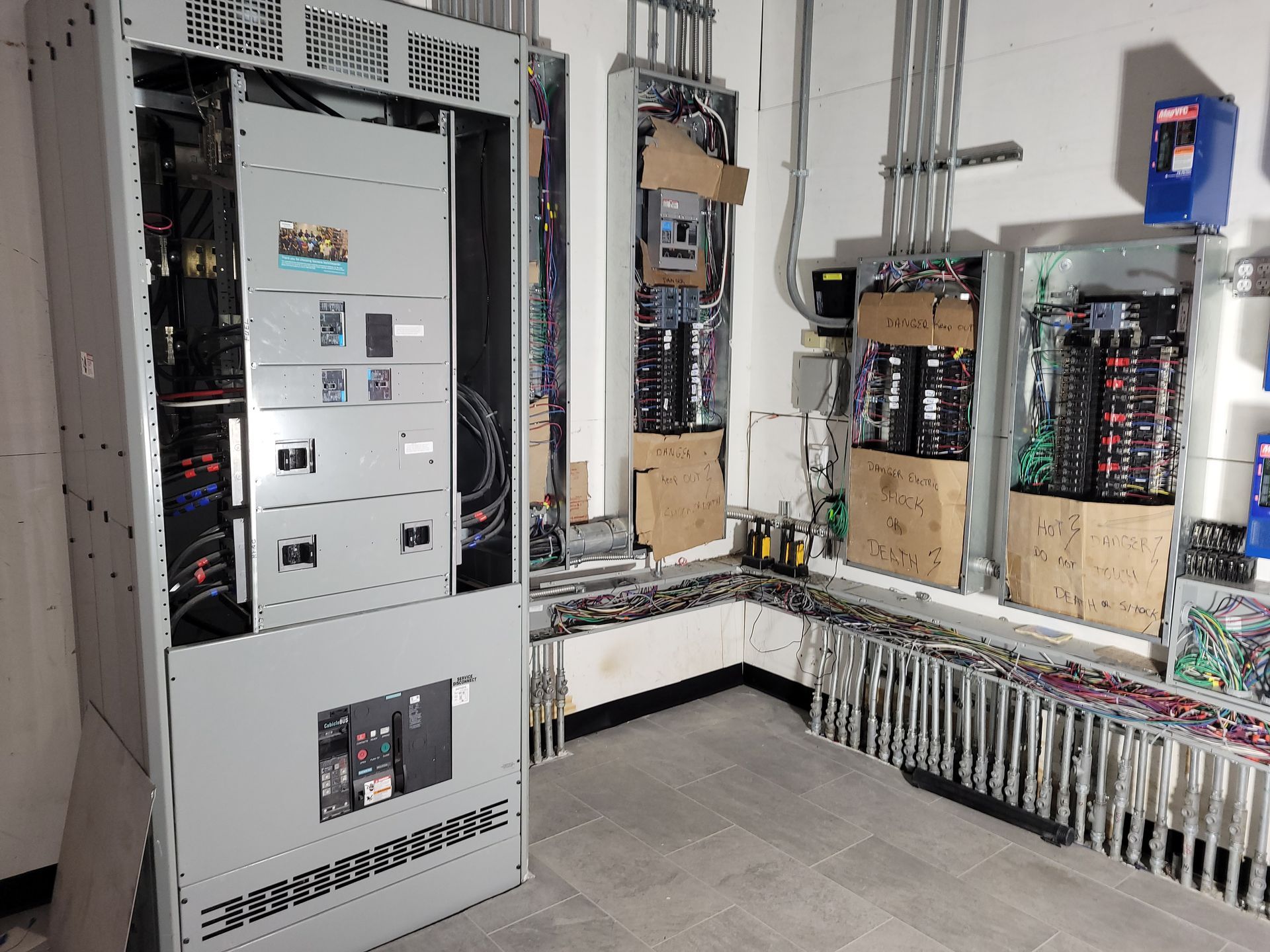 A room with a lot of electrical panels and boxes