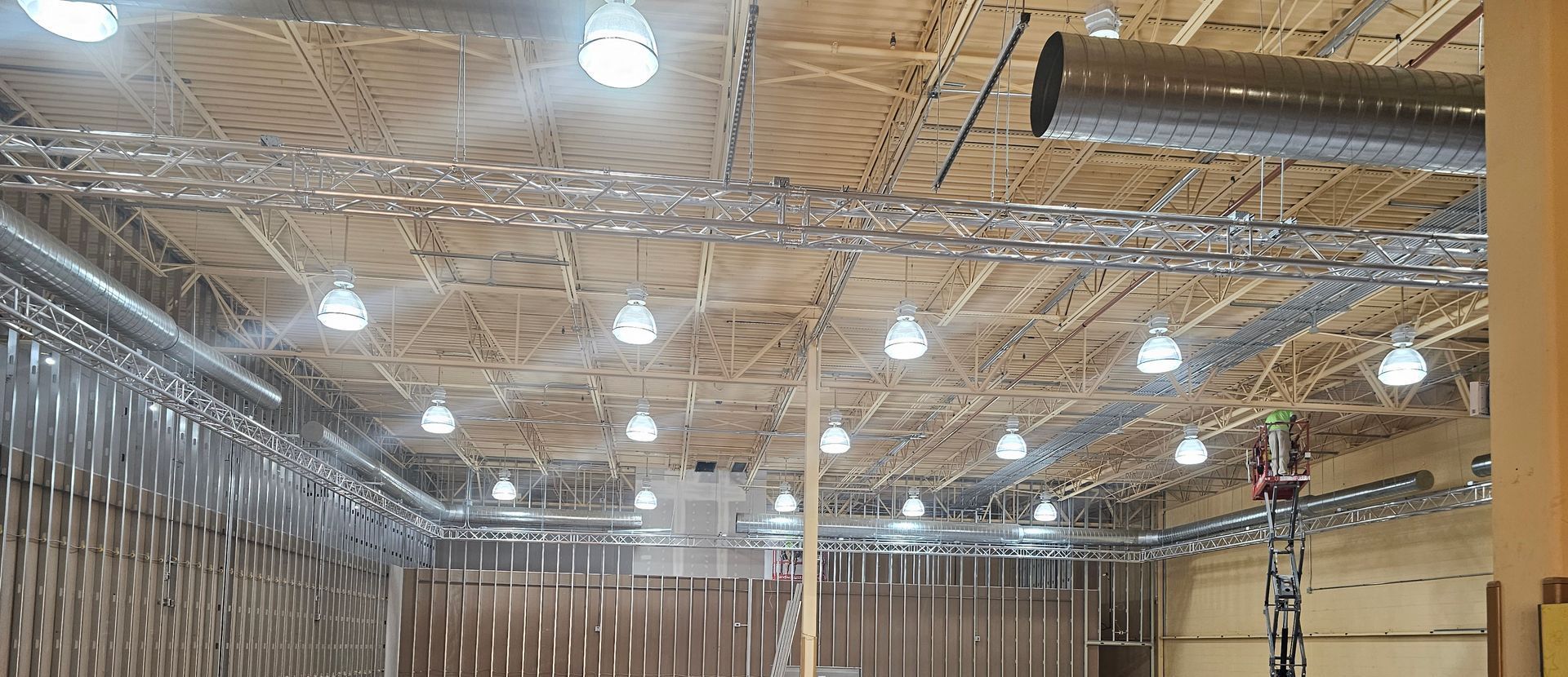 A large room with a lot lights on the ceiling.