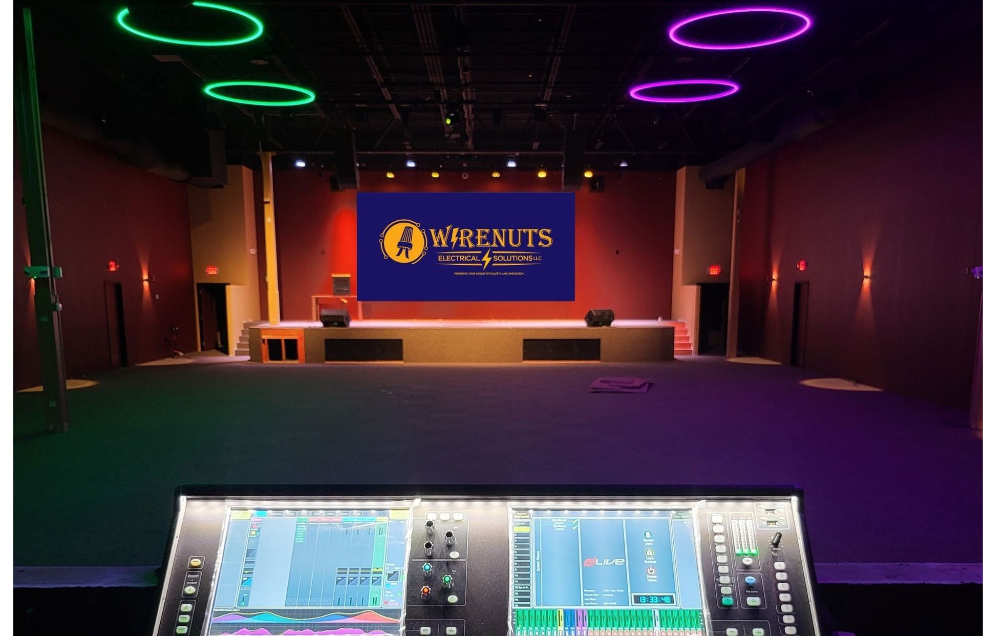 A large room with a stage and a screen that says ' wherenuts ' on it.
