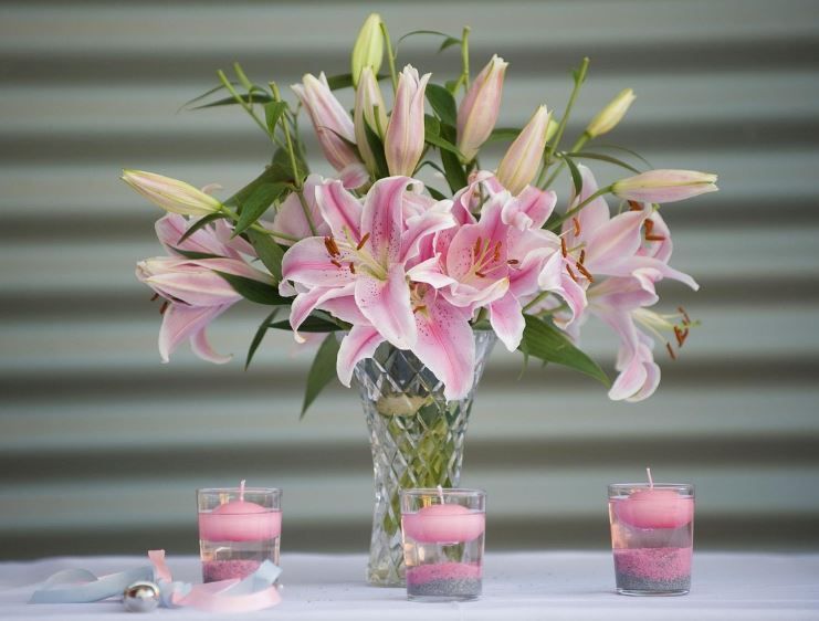 Pink lilies in vase with three tea lights, blending memorial needs, cremation services Upper Darby, 