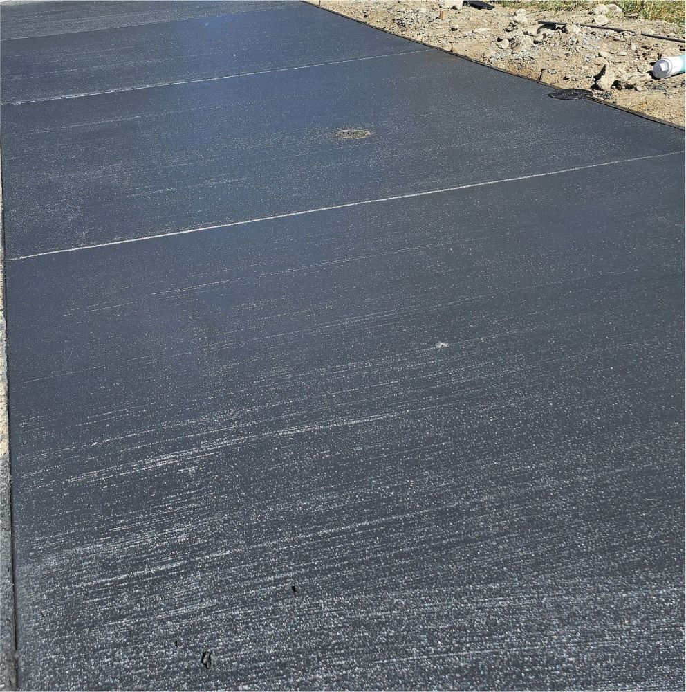 A black asphalt road with a white line in the middle