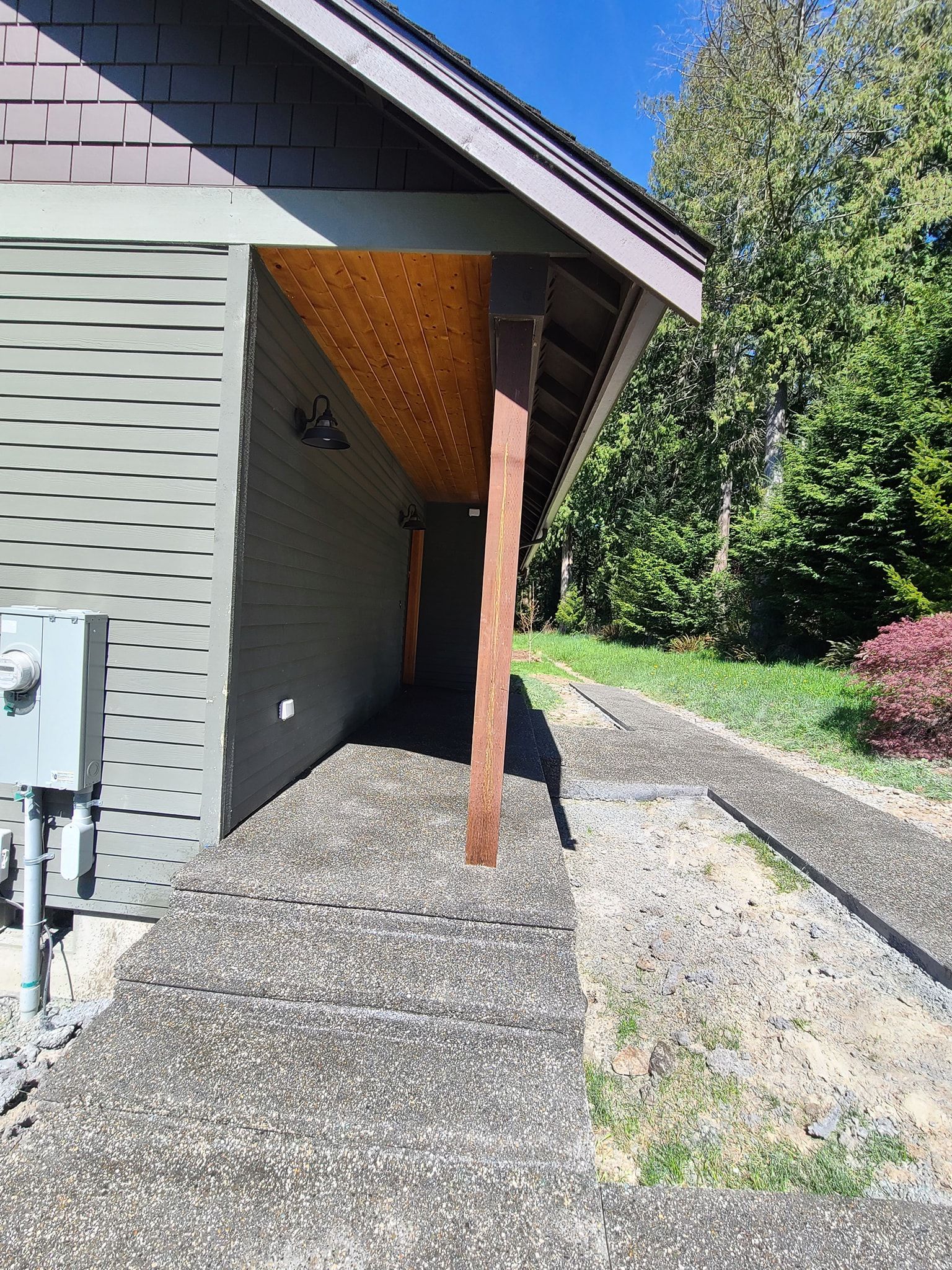 A house with a covered walkway leading to it.