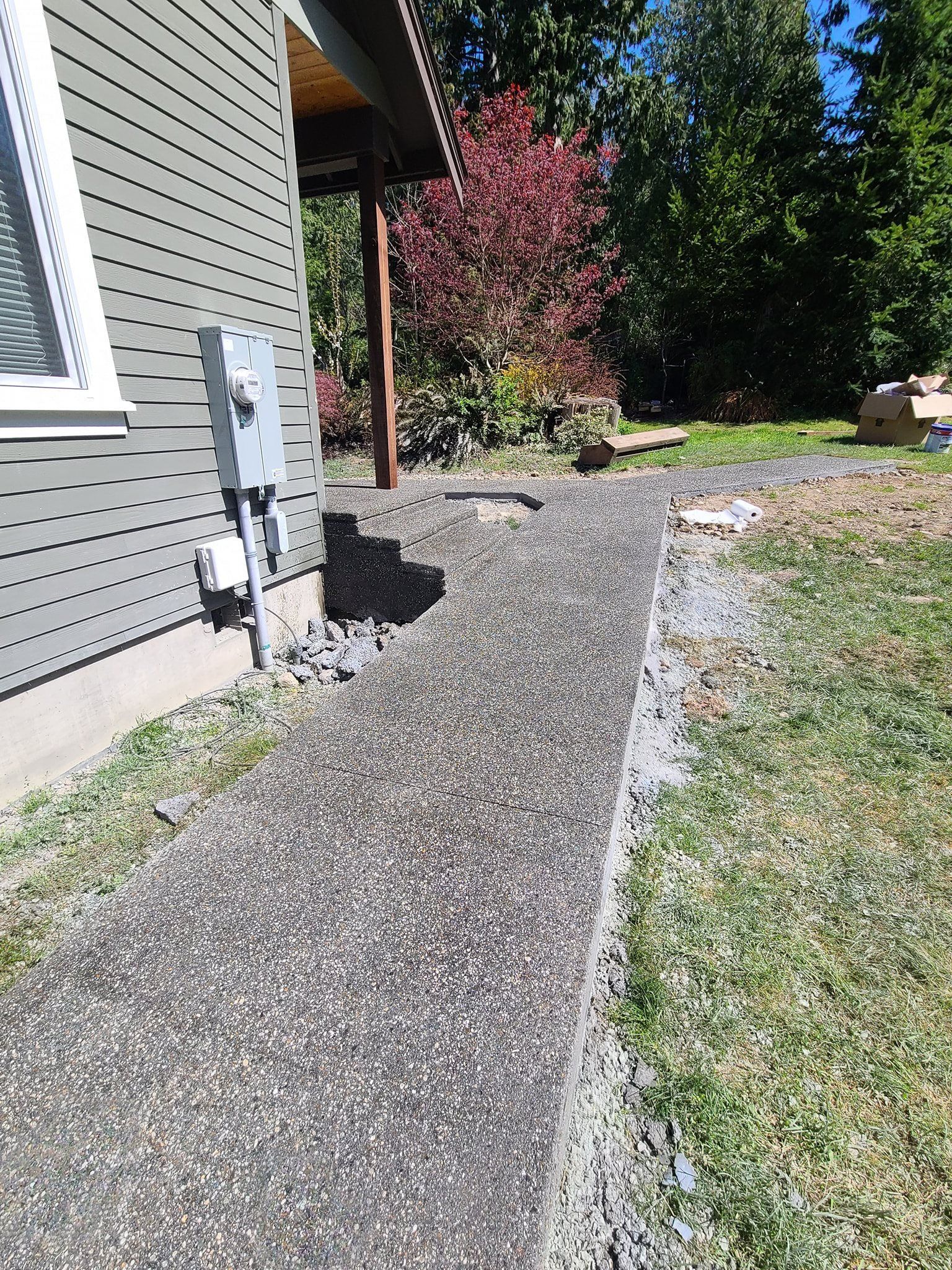 A sidewalk is being built in front of a house.
