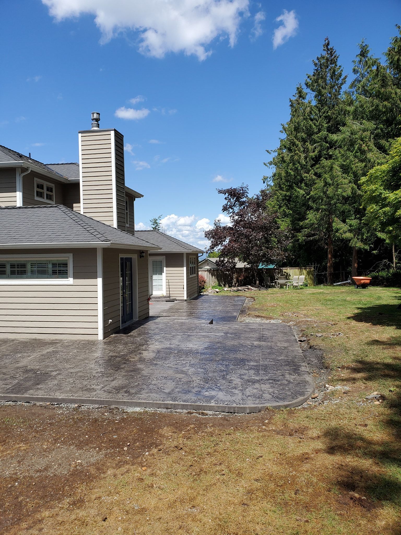 A house with a concrete driveway in front of it