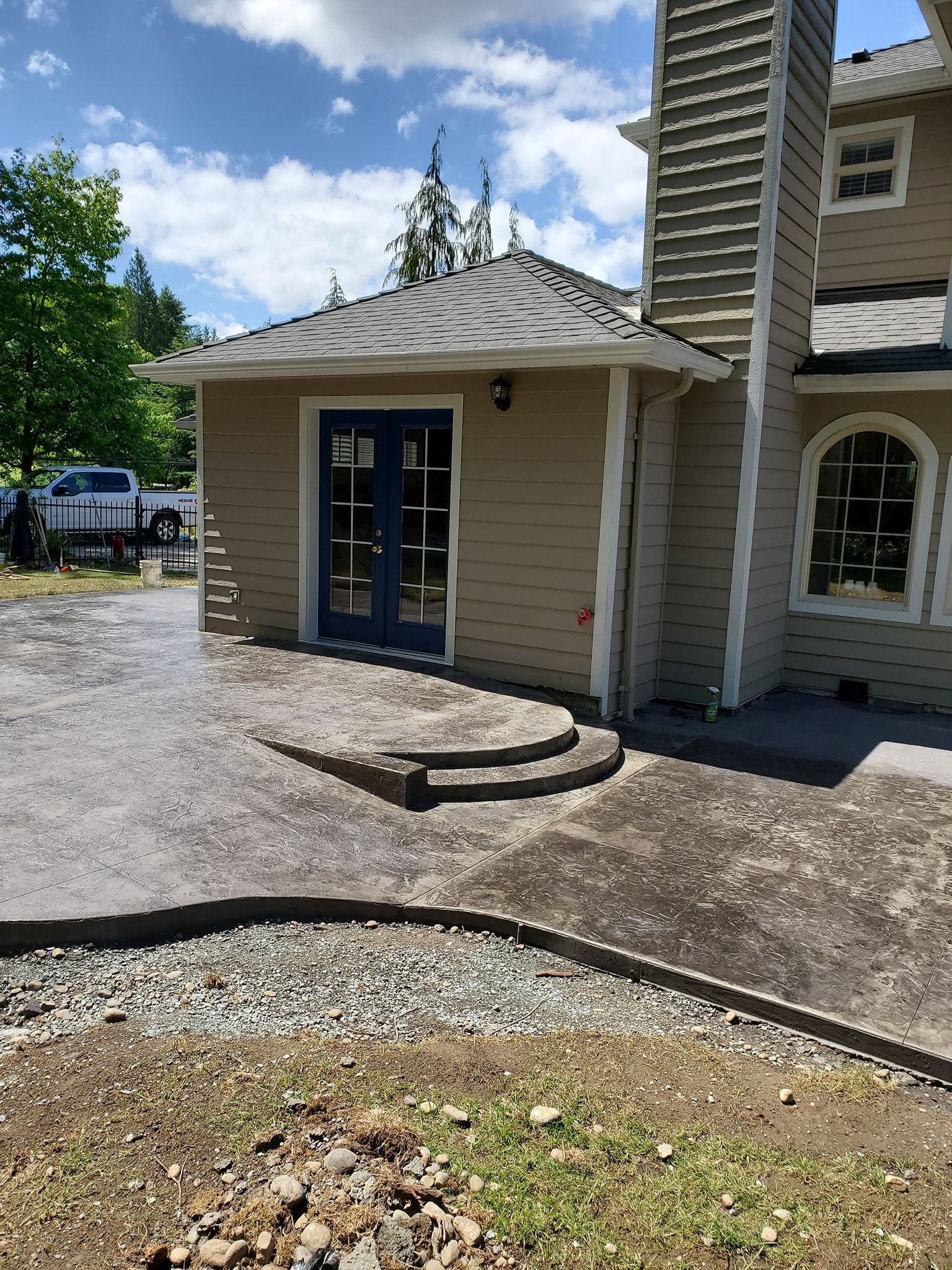 A large house with a driveway and steps leading to it.