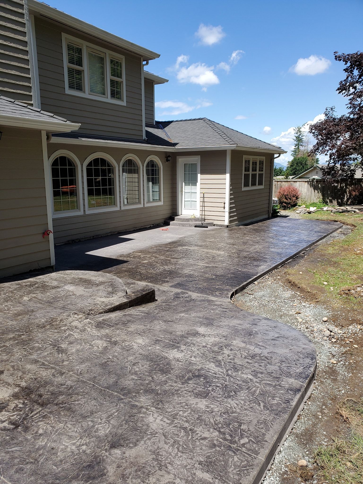 A large house with a concrete driveway in front of it.