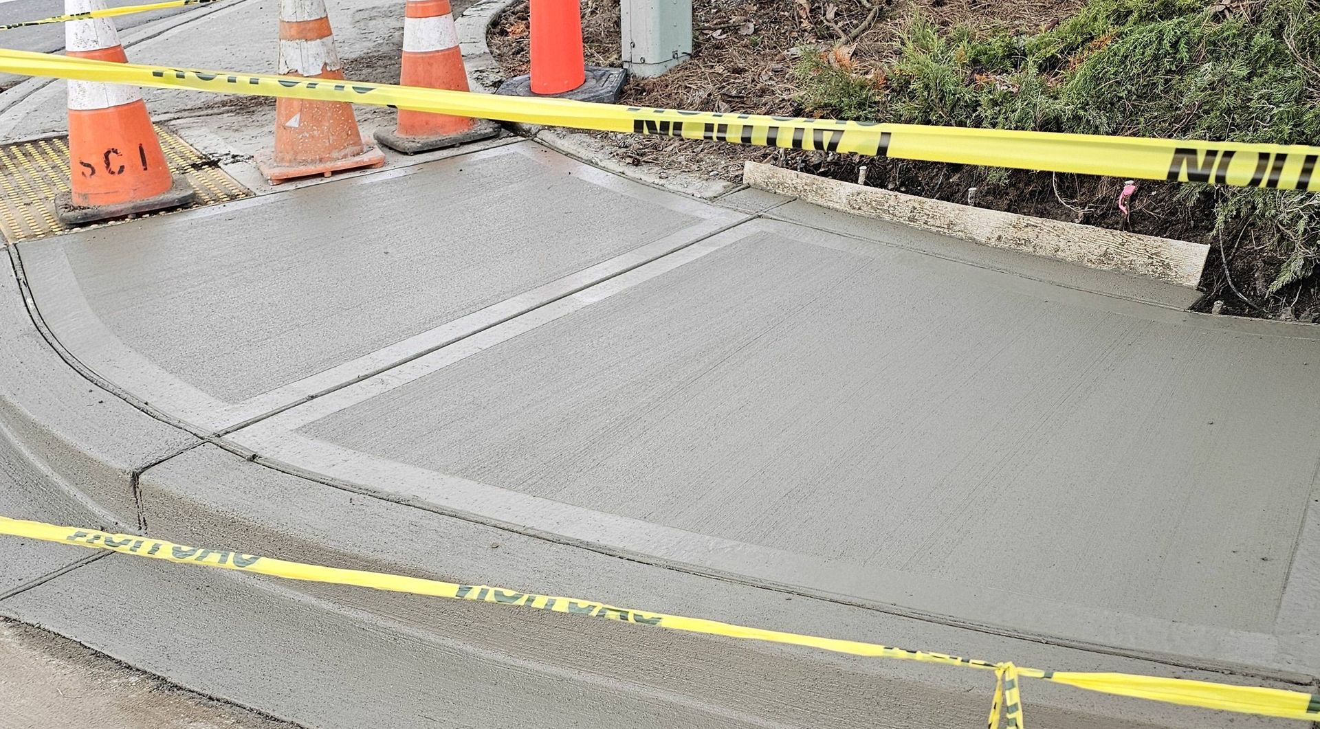 A concrete sidewalk with a yellow tape around it