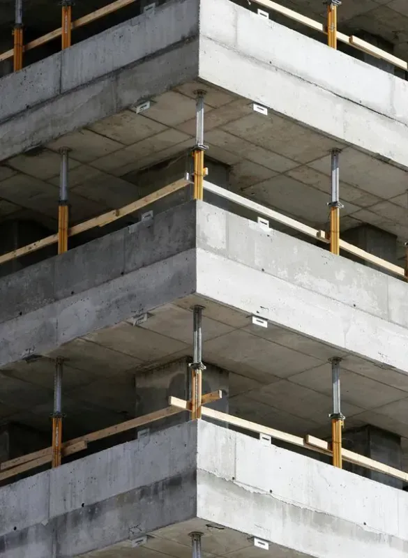 A building under construction with a lot of balconies