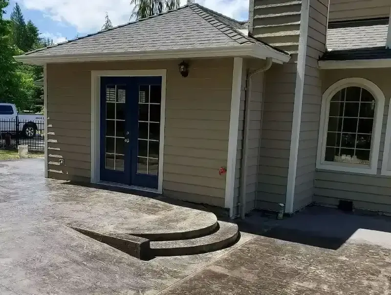 A house with a blue door and steps leading to it
