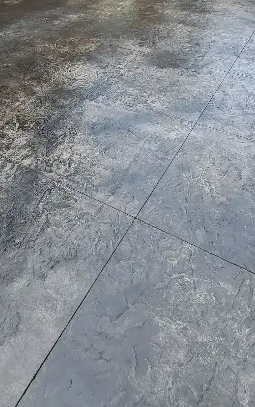 A close up of a concrete floor with a diagonal line.