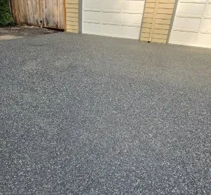 Dark gray concrete driveway in front of a garage in Ferndale WA.