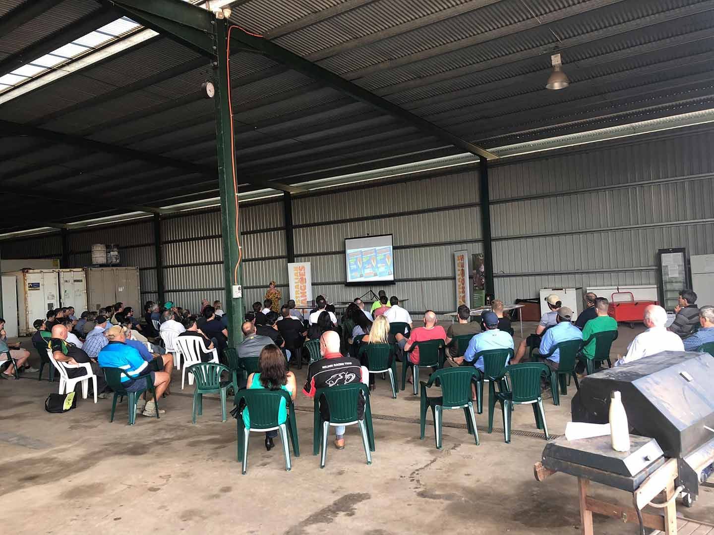 A Group Of People Are Sitting In Chairs In A Warehouse — TGT Pty Ltd in Mareeba, QLD