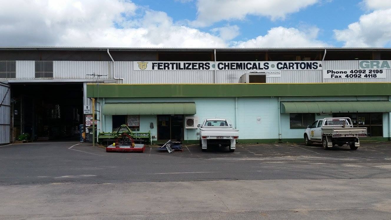 Two Trucks Are Parked In Front Of A Building — TGT Pty Ltd in Mareeba, QLD