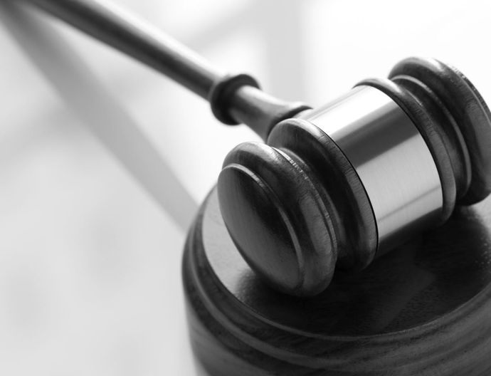 A close up of a judge's gavel on a table.