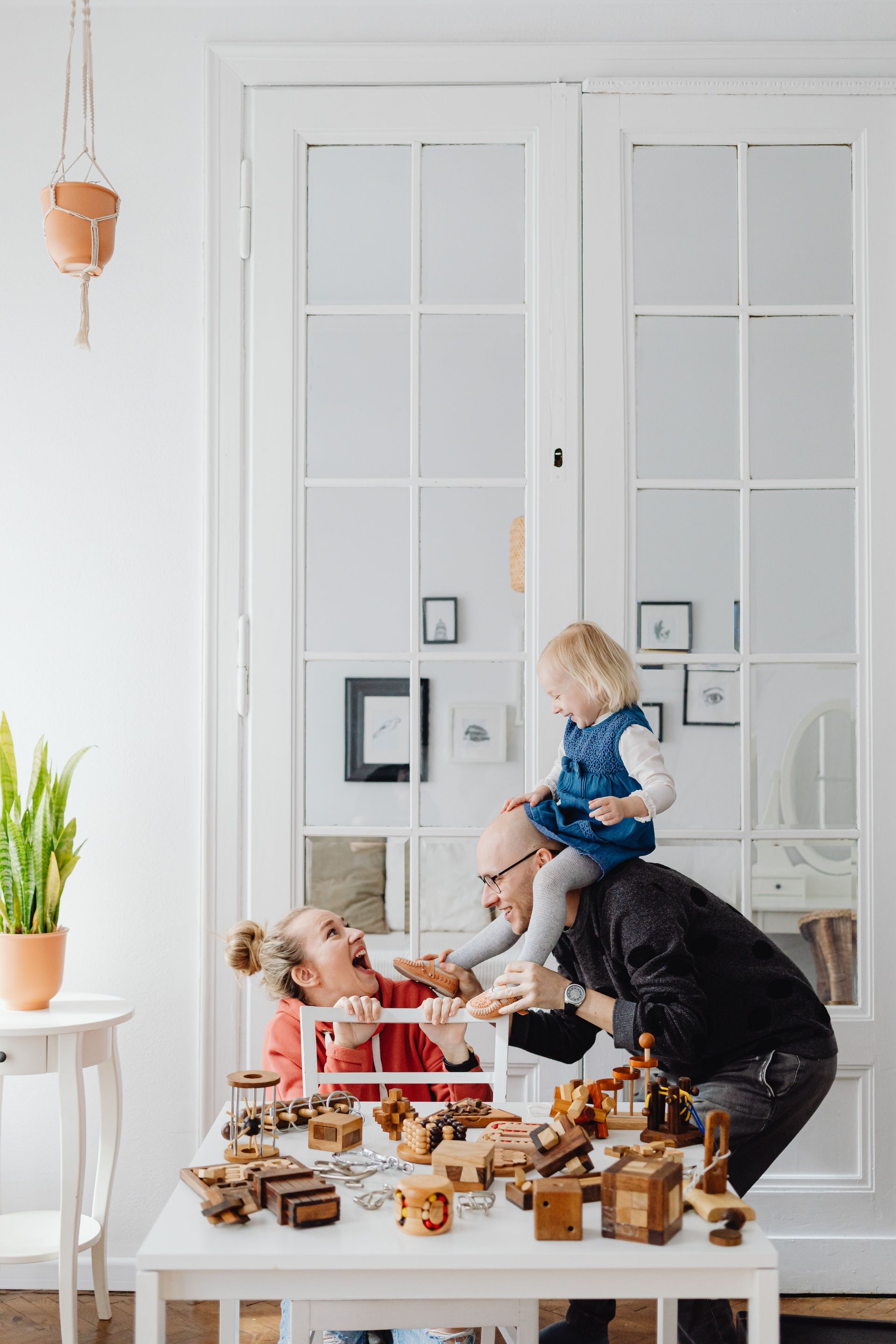 Happy family relaxing together at home, protected by their health coverage