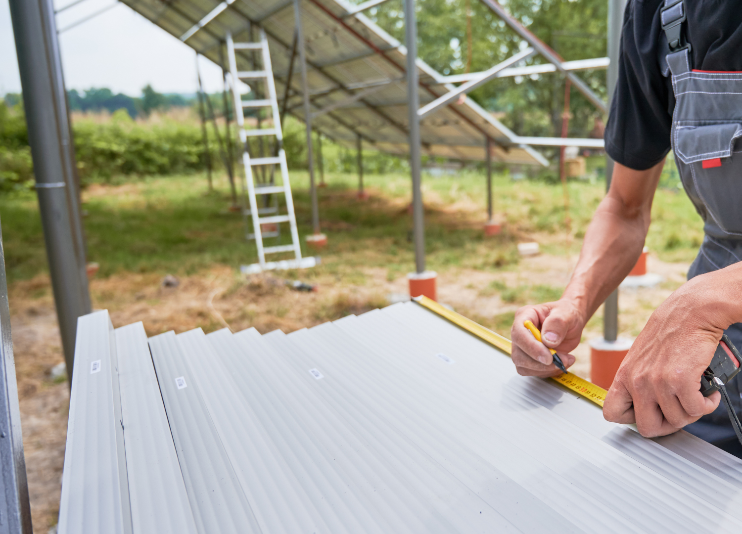 a man is measuring a piece of metal with a tape measure .