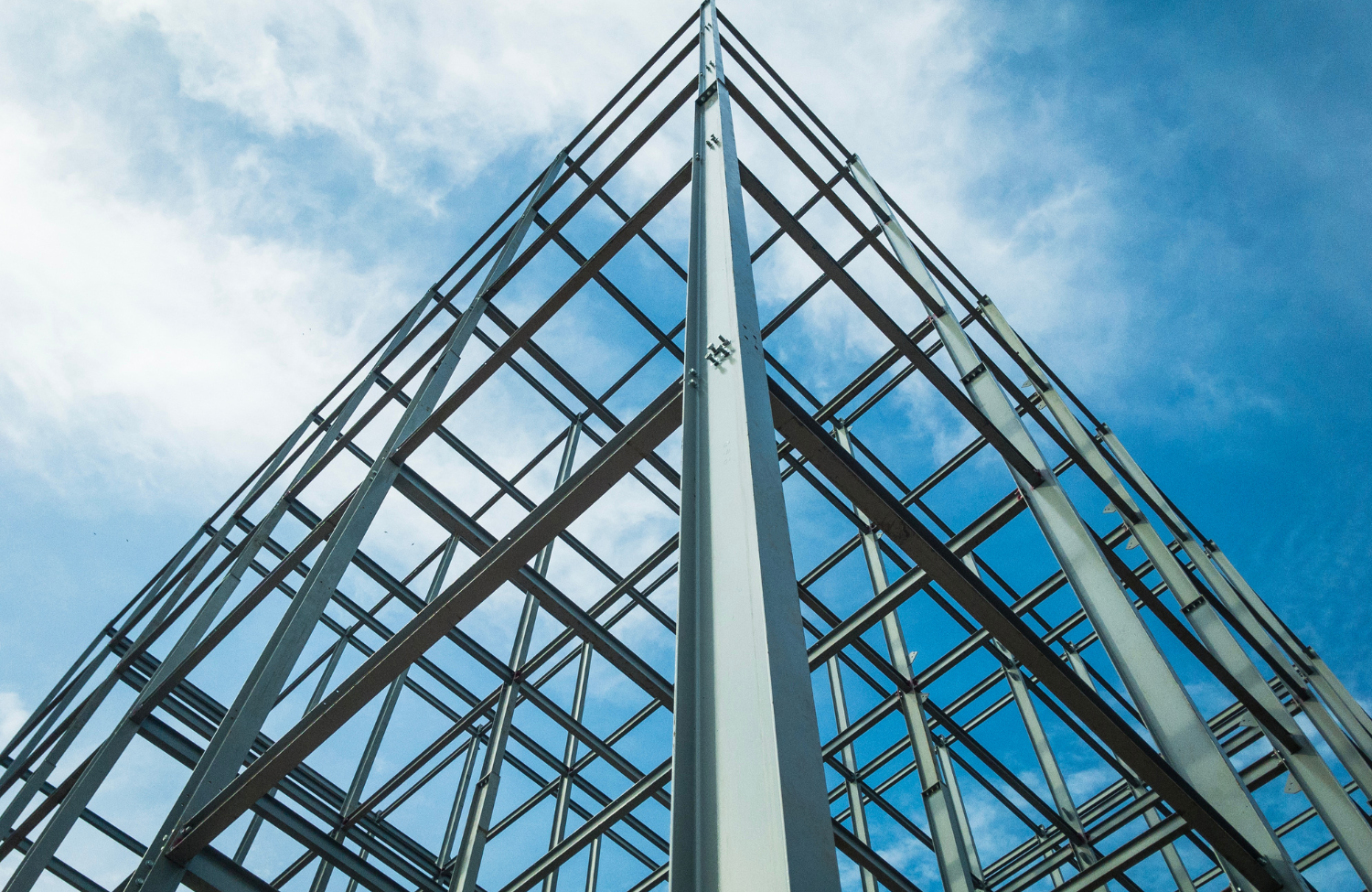 looking up at a building under construction with a blue sky in the background .