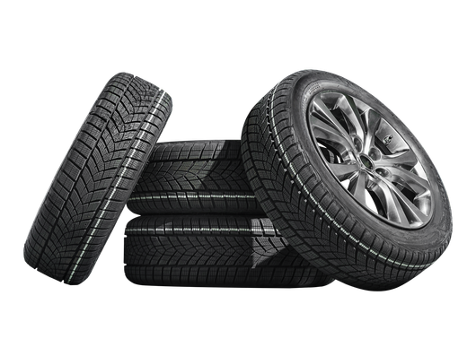 Four black car tires stacked on a white background, one showing a silver alloy wheel.