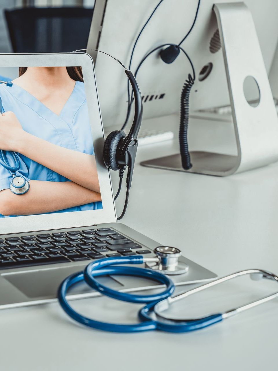 A laptop computer with a picture of a doctor and nurse on the screen.