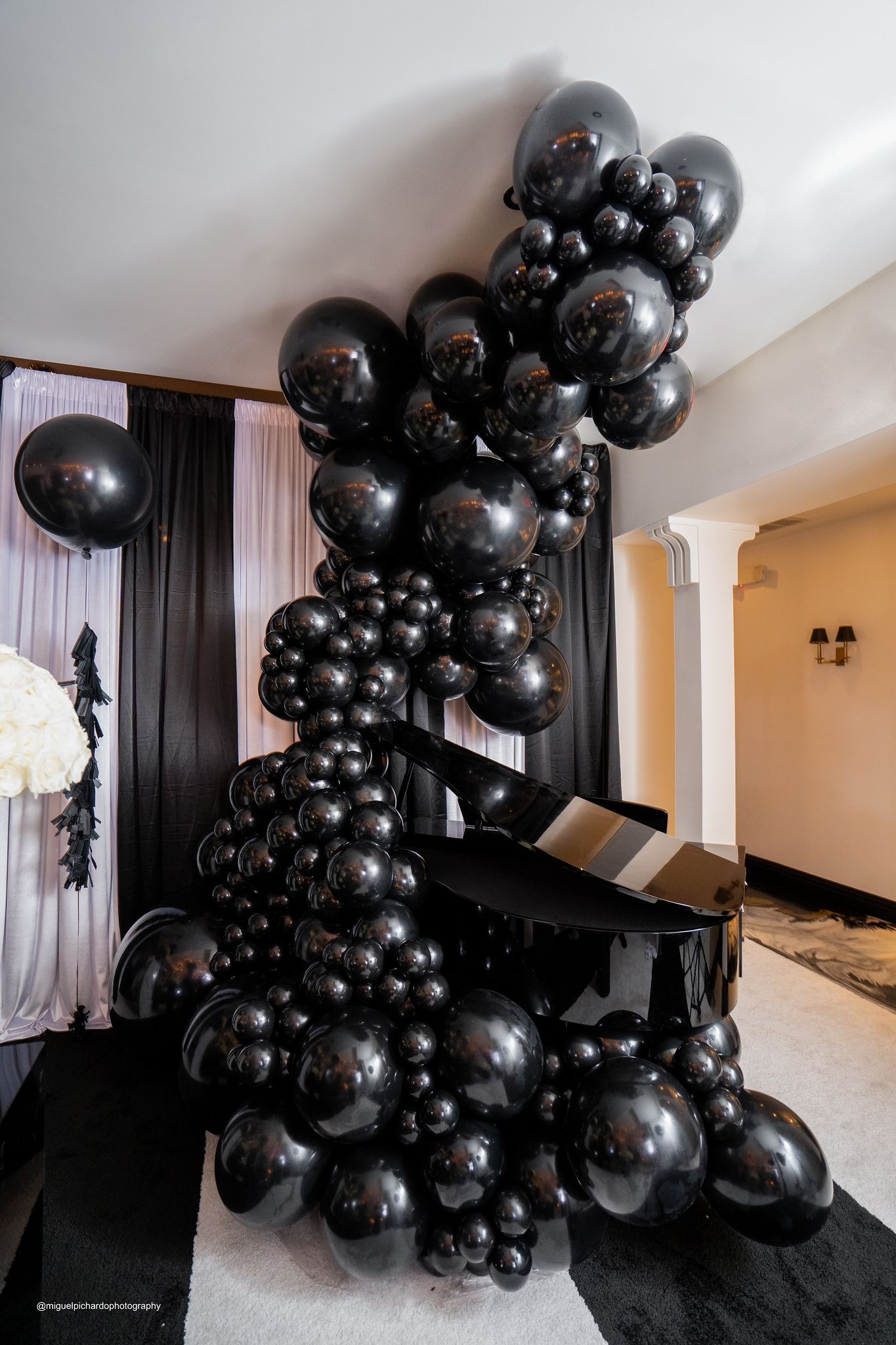 A popcorn box made out of balloons in a hallway