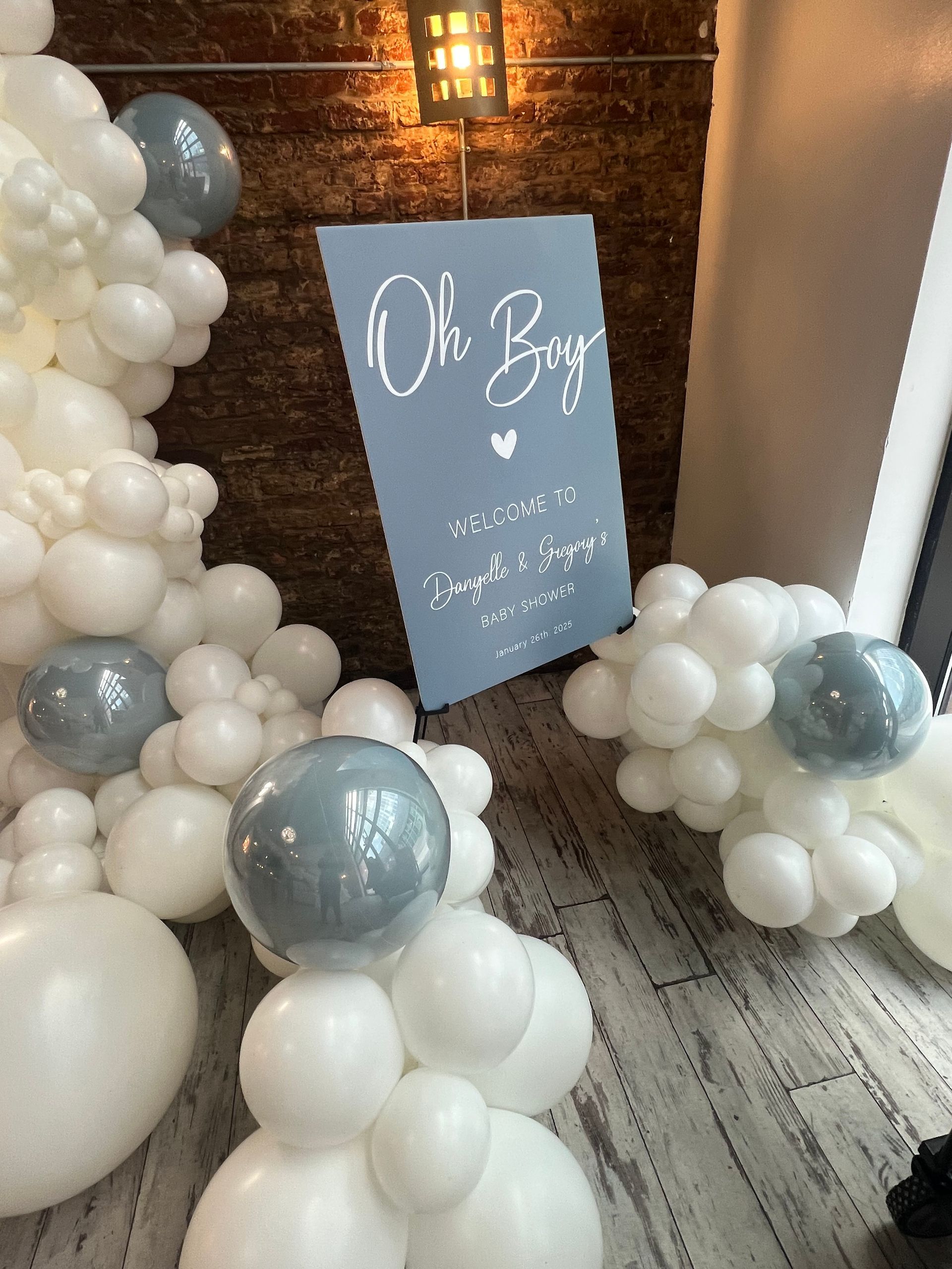 A room filled with white balloons and a sign that says `` oh boy ''.