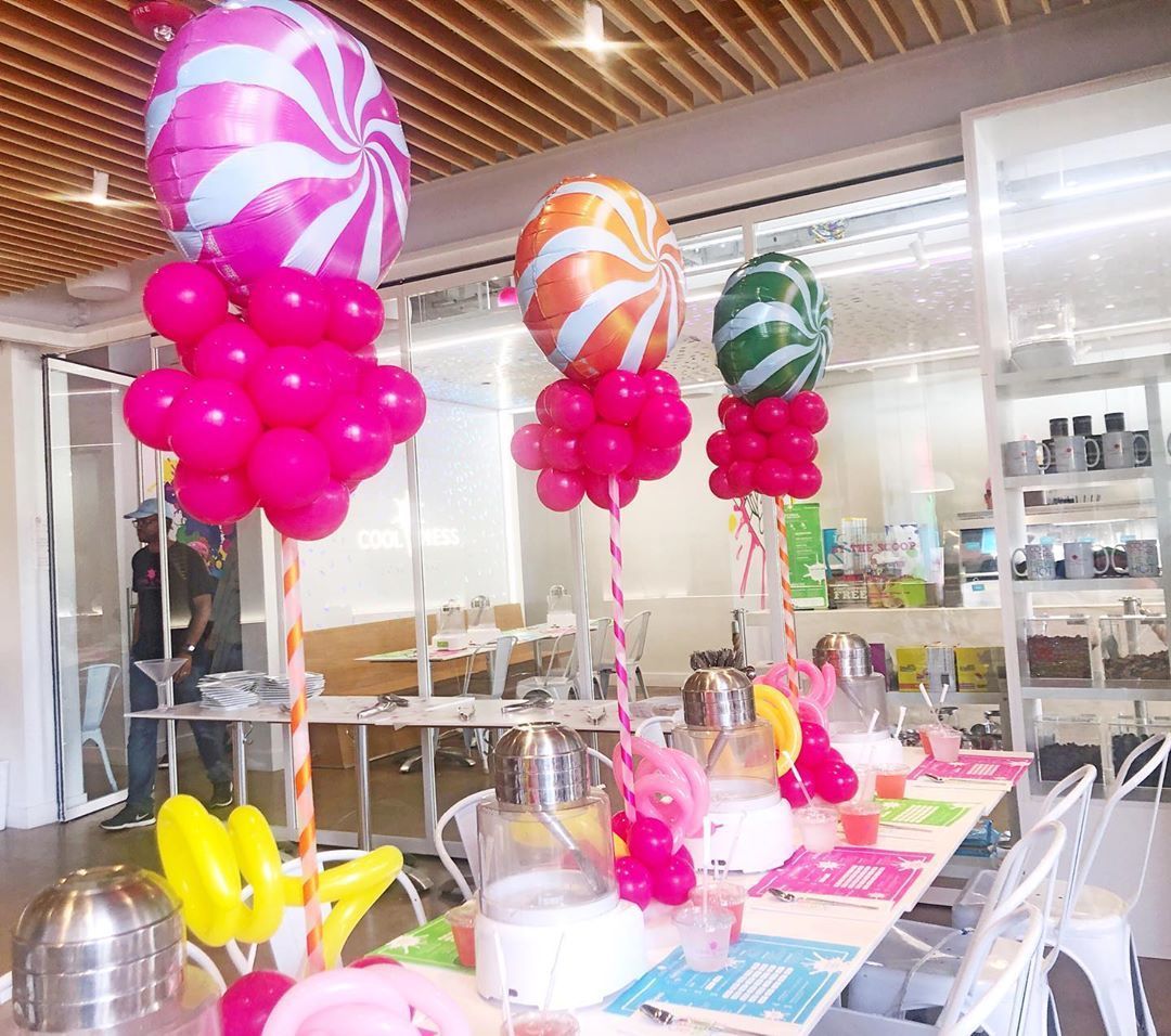 A table is decorated with balloons in the shape of candy canes.