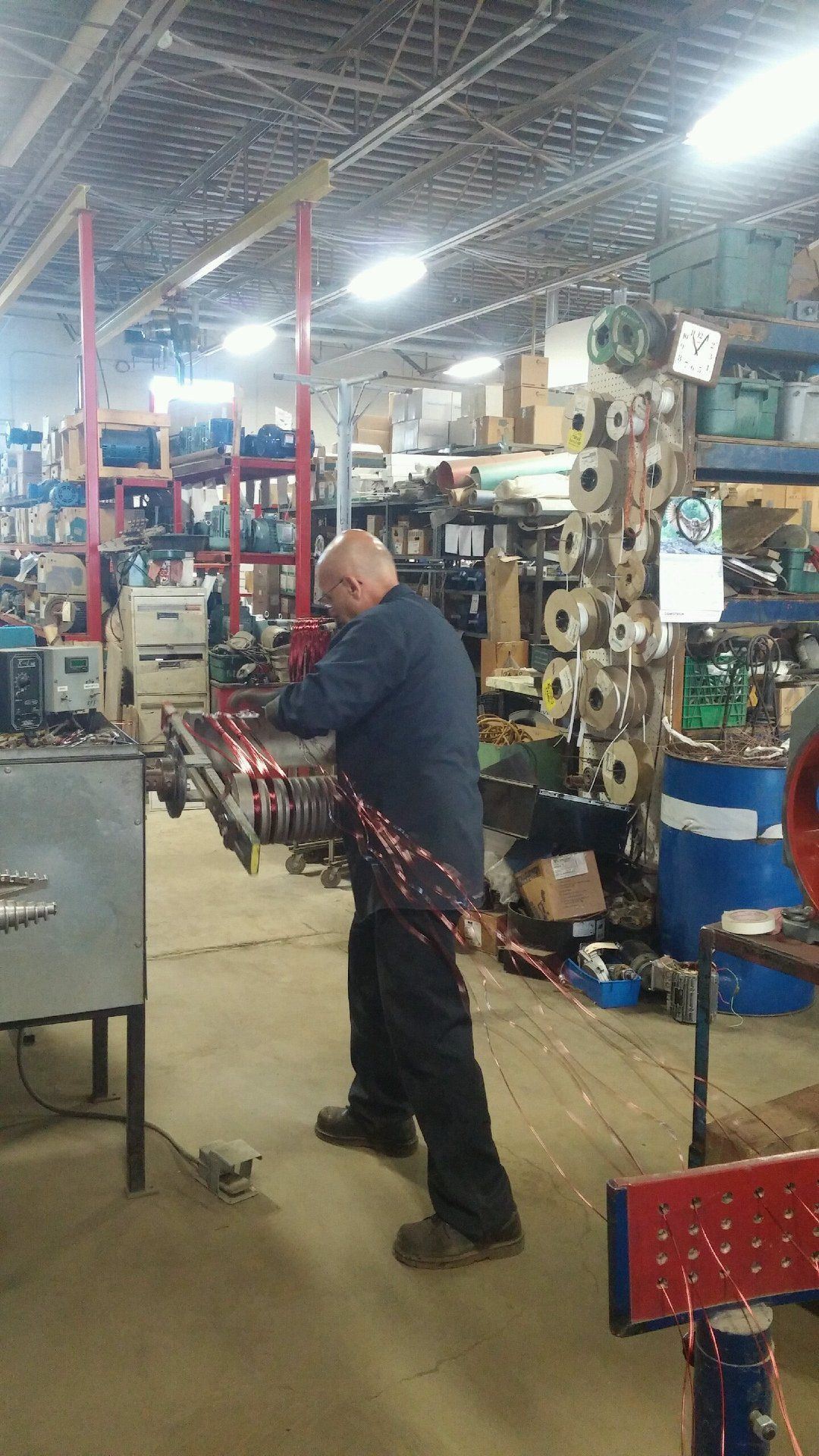 A man is working on a machine in a factory.