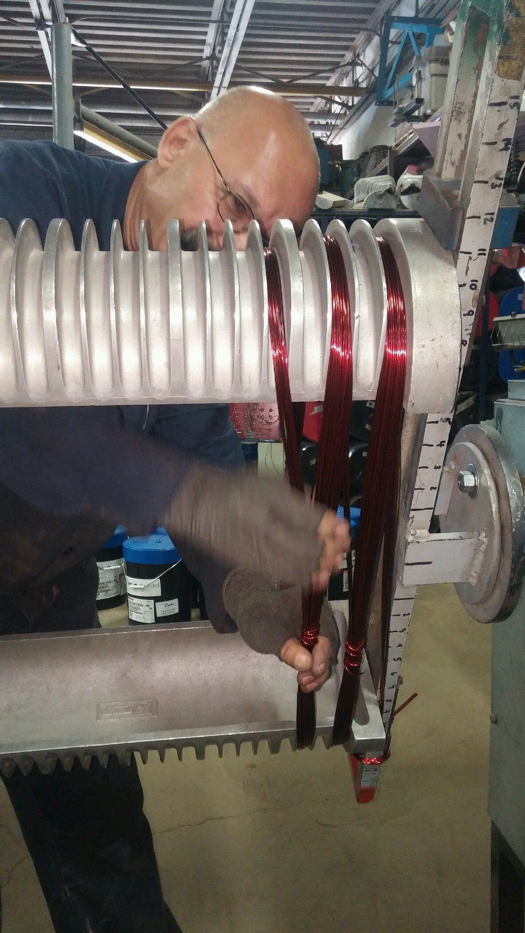 A man is working on a machine in a factory.