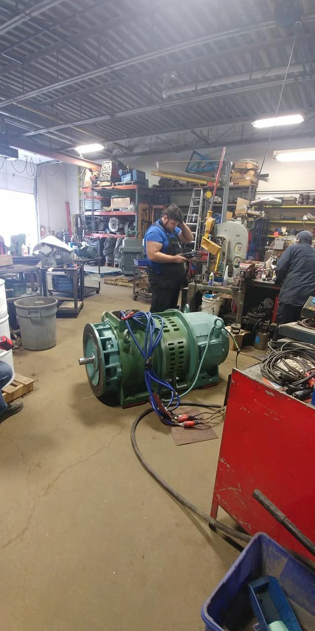 A group of people are working on a large machine in a factory.