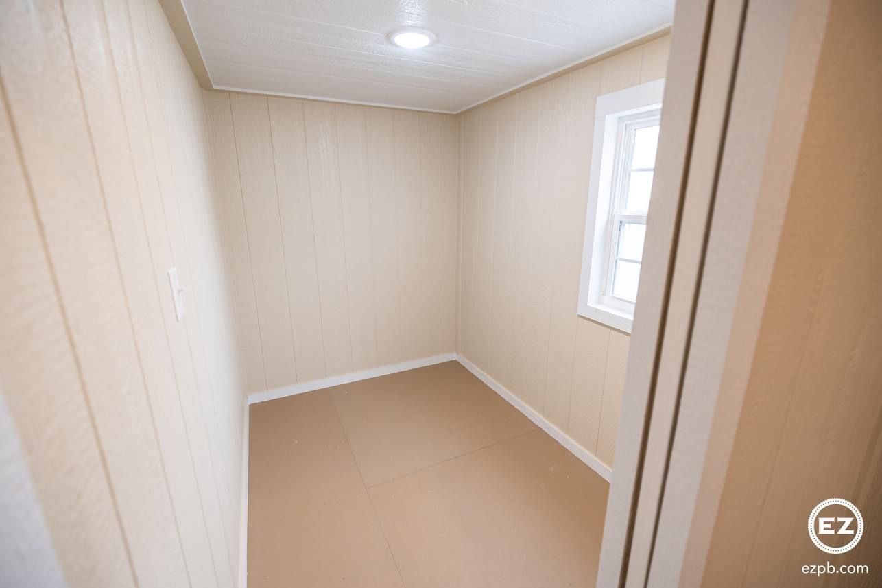 An empty room with a window and a door.