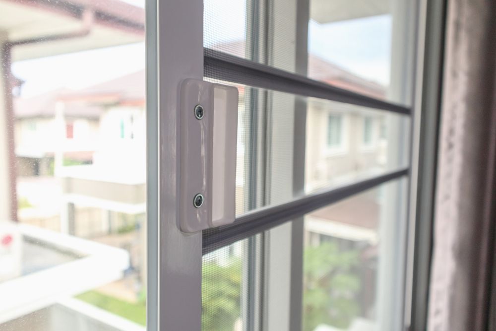 Open Window with Metal Security Bars and A Blurred Outdoor View — Fineworx Joinery in Warnervale, NSW