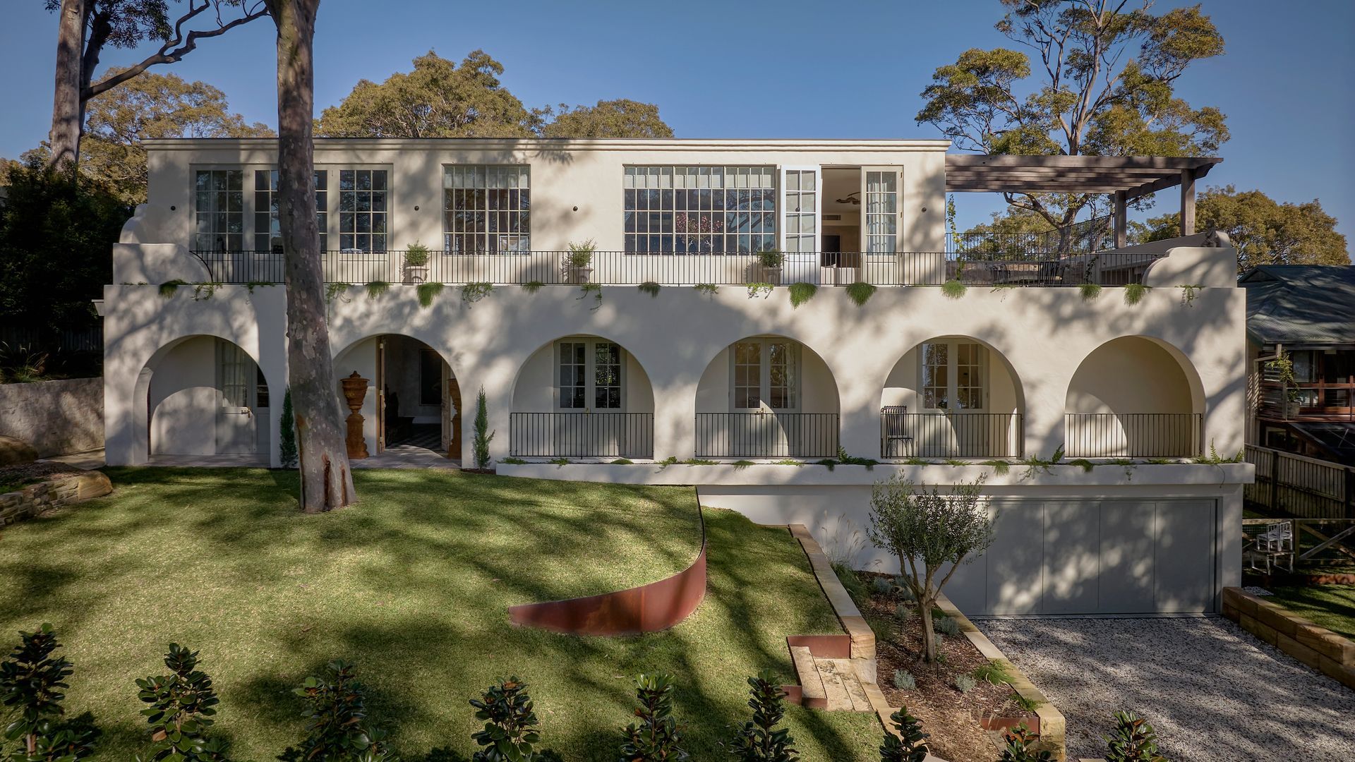 Modern White House With Arched Terrace on a Sunny Grassy Hillside — Fineworx Joinery in Warnervale, NSW