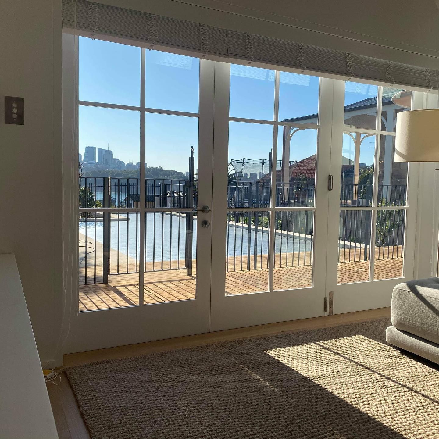 Bright Living Room with French Doors Opening to A Sunny Balcony and City View — Fineworx Joinery in Warnervale, NSW