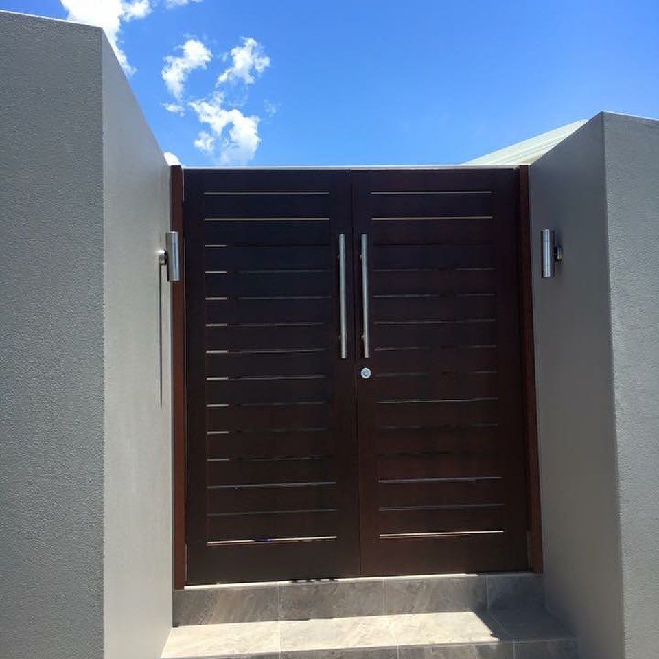 Dark Brown Double Gate Between Grey Walls — Fineworx Joinery in Warnervale, NSW