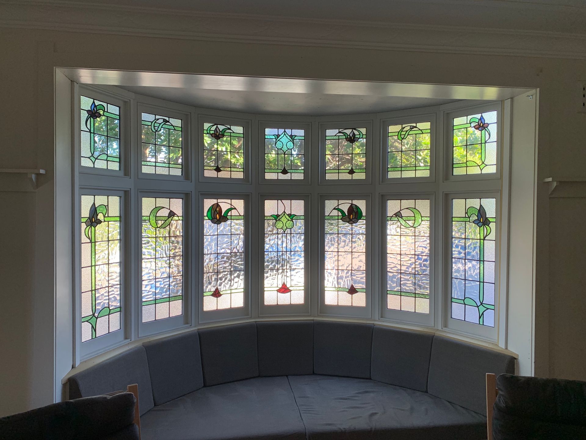 Curved Bay Window With White Trim, Stained-glass Panes — Fineworx Joinery in Warnervale, NSW