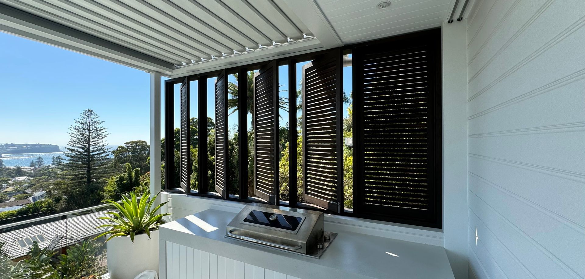 Modern Kitchen Window With Black Shutters, White Countertop — Fineworx Joinery in Warnervale, NSW