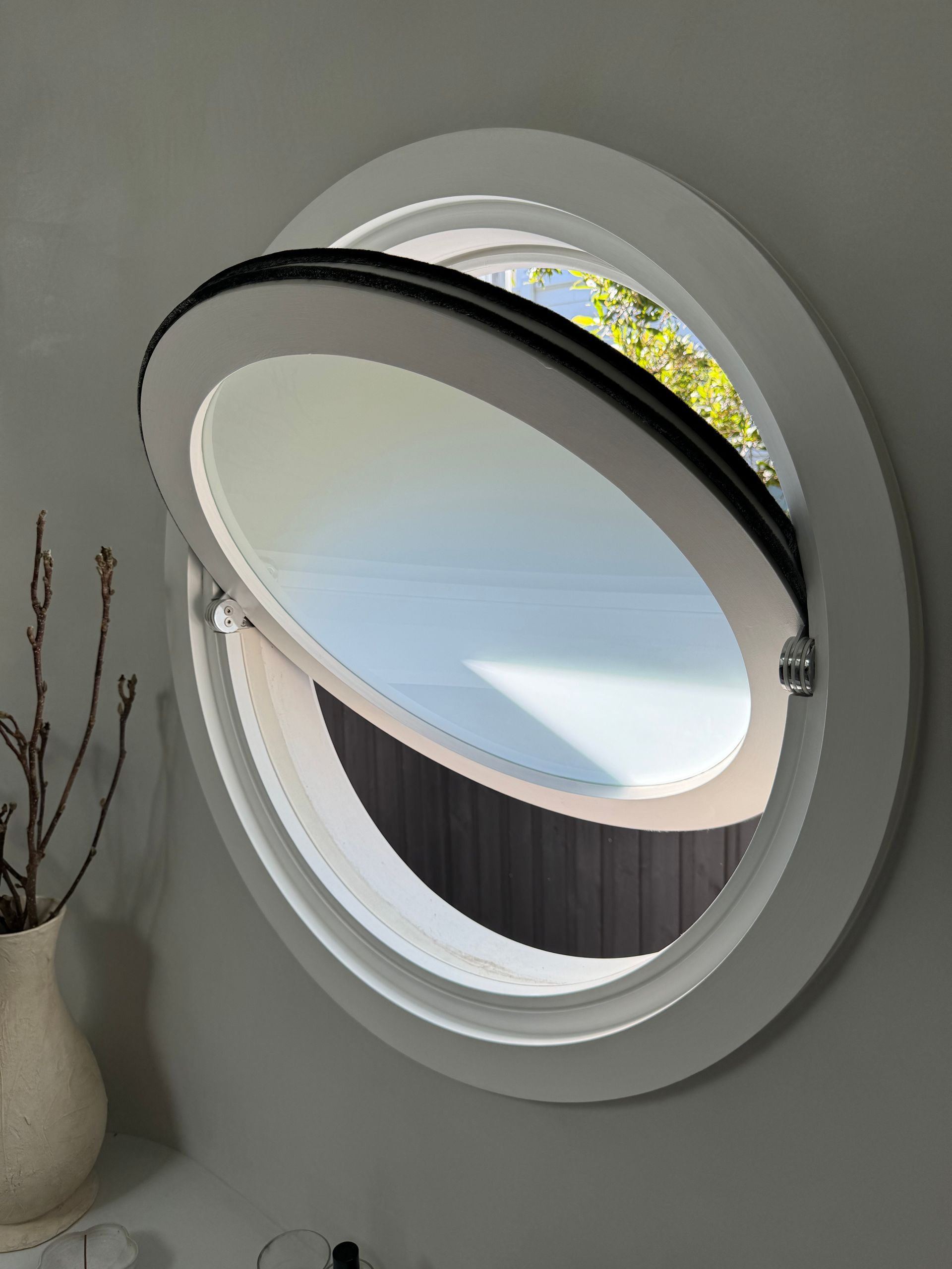 Open Round Window With Tilted White Shutter and Black Trim — Fineworx Joinery in Warnervale, NSW