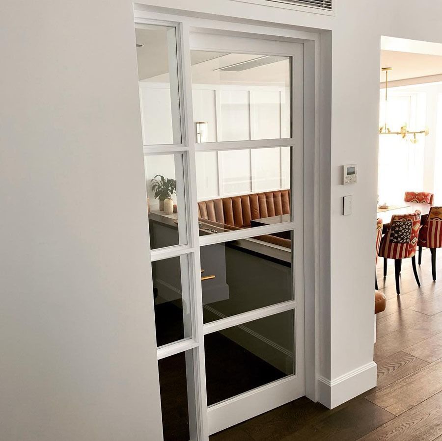 White Framed Interior Doorway with Glass Panes Opening to A Dining Room — Fineworx Joinery in Warnervale, NSW
